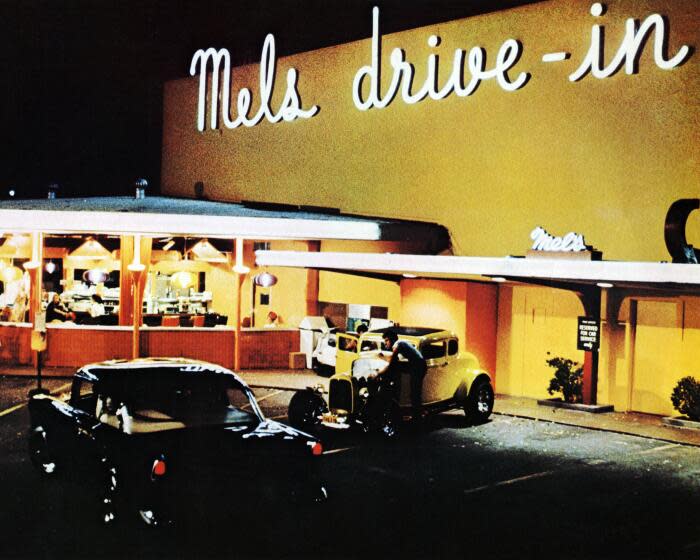 A night-time scene outside Mel's Drive-In in San Francisco, California, from the film 'American Graffiti', 1973. The film was directed by George Lucas. (Photo by Silver Screen Collection/Getty Images)