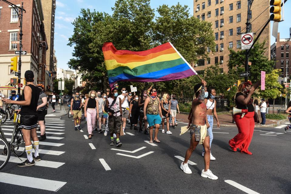 Gay rights activists march near the Stonewall Inn on July 16, 2020, in New York City.