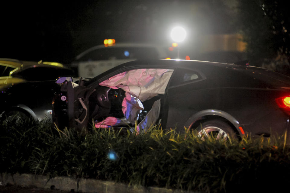 New Orleans Police Department officers process a damaged vehicle after responding to a fatal hit and run accident along Esplanade Avenue in Bayou St. John in New Orleans, Saturday, March 2, 2019. Authorities say several people have been killed and others injured after being struck by a vehicle on a busy New Orleans thoroughfare. (Shawn Fink/The Advocate via AP)