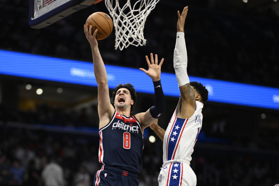 Washington Wizards forward Deni Avdija (8) goes to the basket against Philadelphia 76ers forward KJ Martin during the first half of an NBA basketball game Saturday, Feb. 10, 2024, in Washington. (AP Photo/Nick Wass)