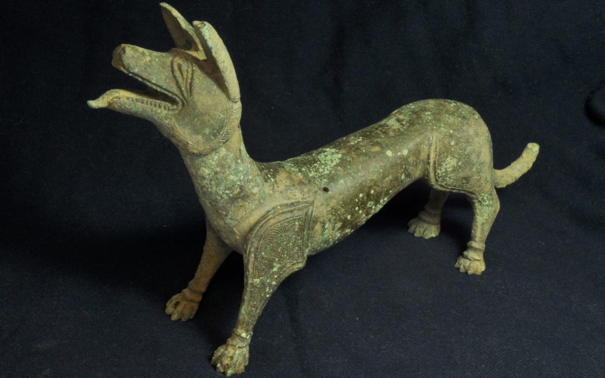 The bronze sculpture of a 'licking dog' discovered in Gloucestershire by metal detector enthusiasts Pete Cresswell and his brother in law Andrew Boughton - PA