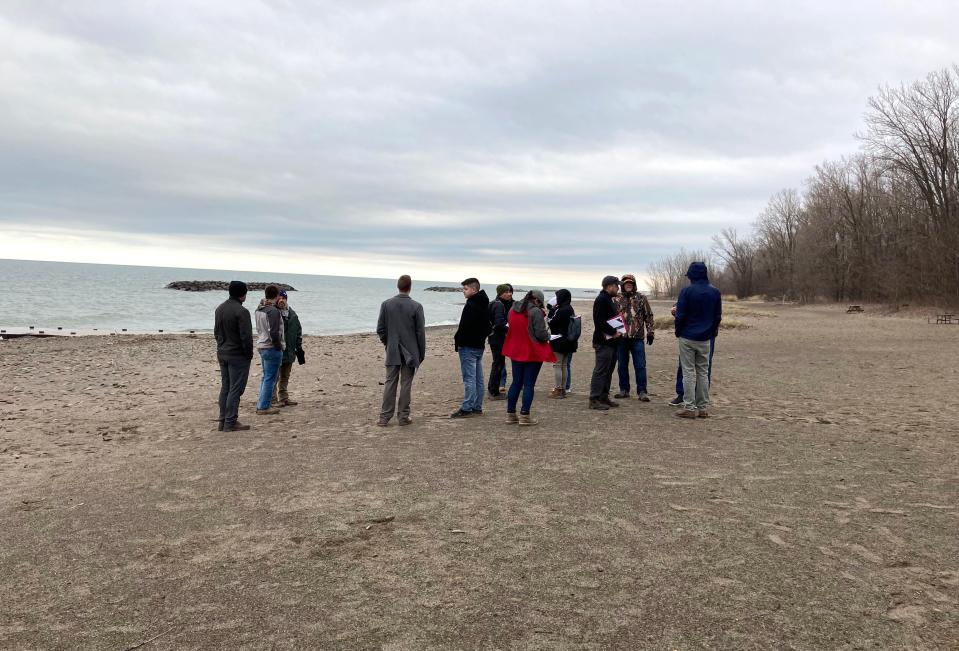 Officials from the U.S. Army Corps of Engineers, state Department of Conservation and Natural Resources, Presque Isle Advisory Committee and others prepare to start the spring beach walk on March 27, 2024, at Presque Isle State Park to evaluate conditions after winter and see where sand will need to be placed.