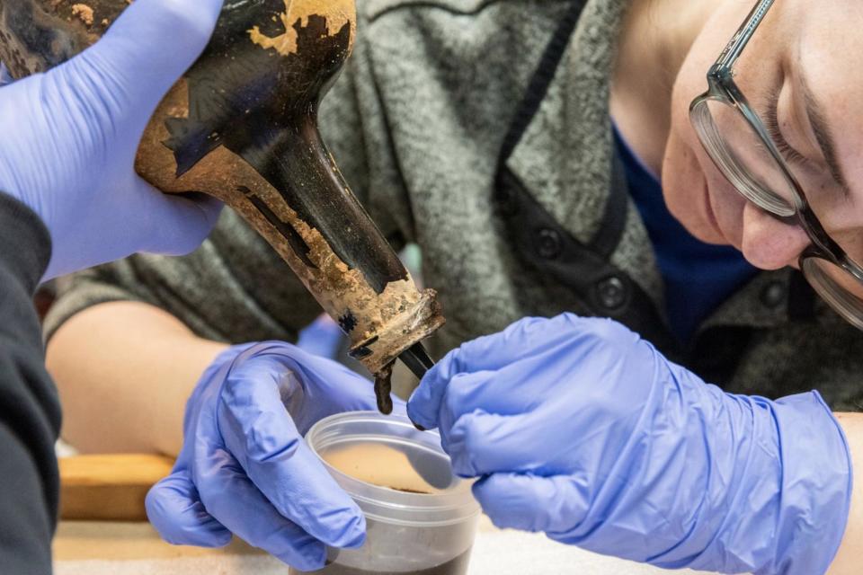Archaeological Analyst Alice Keith extracting the contents of one of the about 250-year-old bottles recently unearthed at Mount Vernon. (The Mount Vernon Ladies' Association)