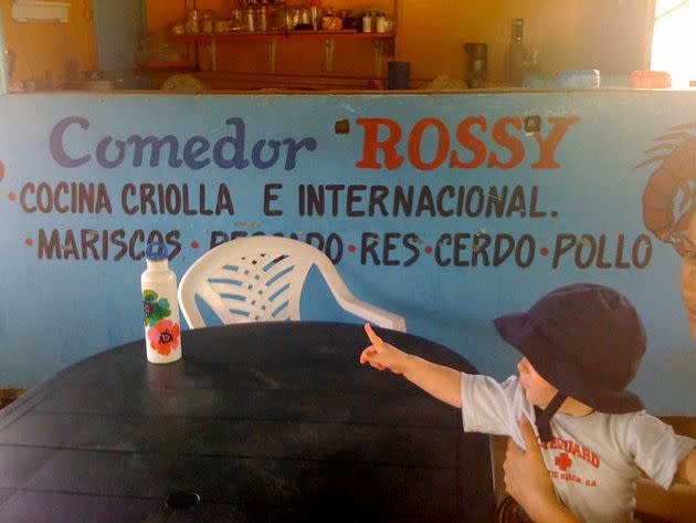 The author's son awaits lunch at a comedor in the Dominican Republic.