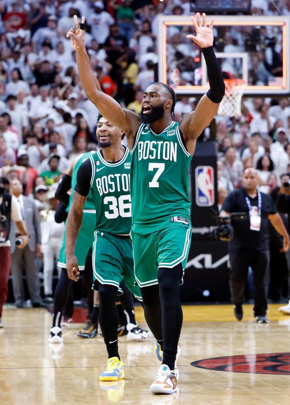 Boston Celtics guard Jaylen Brown (7) and Boston Celtics guard Marcus Smart (36) react after defeating the Heat in Game 6 of the Eastern Conference finals at the Kaseya Center in Miami on Saturday, May 27, 2023.