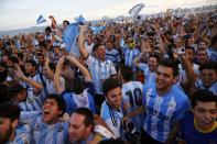 Argentina soccer fans react as they watch a broadcast of the 2014 World Cup semi-final between Argentina and the Netherlands at Copacabana beach in Rio de Janeiro, July 9, 2014. REUTERS/Jorge Silva