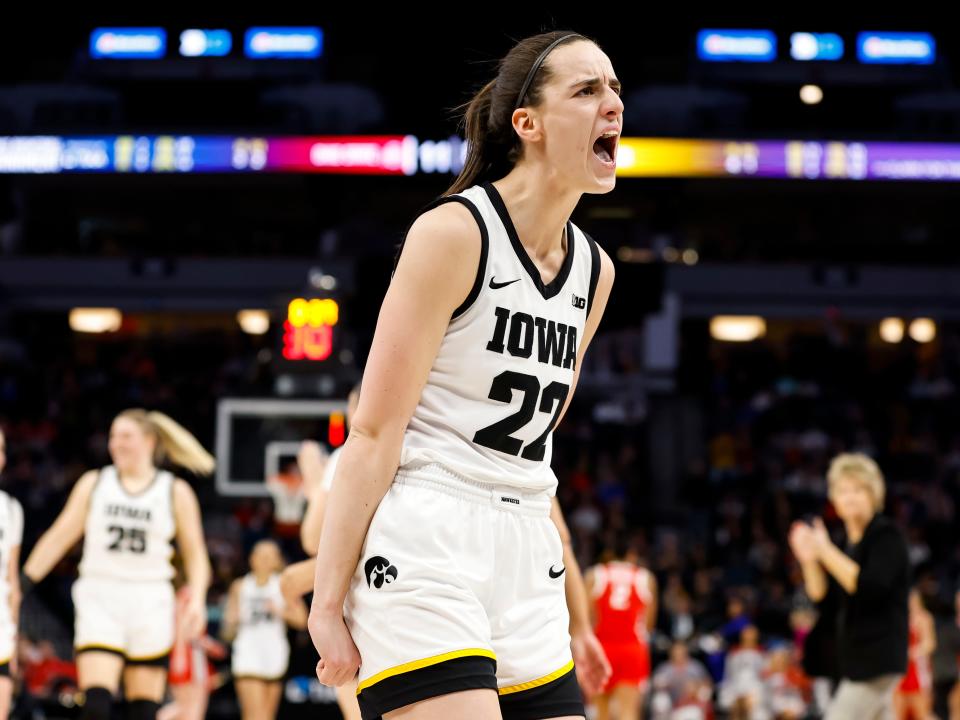 Caitlin Clark #22 of the Iowa Hawkeyes celebrates her three-point basket against the Ohio State Buckeyes in the first half of the championship game of the Big Ten Women's Basketball Tournament at Target Center on March 5, 2023