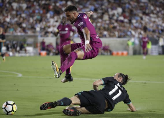 Manchester City’s Kyle Walker, top, avoids a tackle from Real Madrid’s Gareth Bale during the second half of an International Champions Cup soccer match Wednesday, July 26, 2017, in Los Angeles. Manchester City won 4-1. (AP Photo/Jae C. Hong)