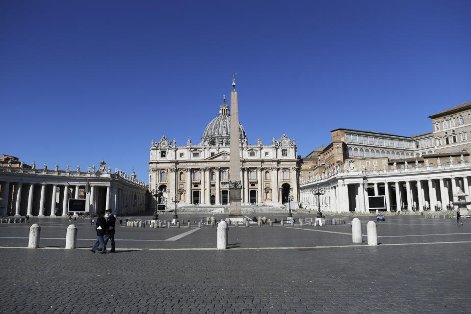 Policemen patrol an empty St. Peter's Square at the Vatican, Sunday, April 4, 2021. Italy has entered a three-day strict nationwide lockdown to prevent new surges of the coronavirus. Police set up road checks to ensure people were staying close to home and extra patrols were ordered up to break up large gatherings in squares and parks, which over Easter weekend are usually packed with picnic-goers. (AP Photo/Gregorio Borgia)