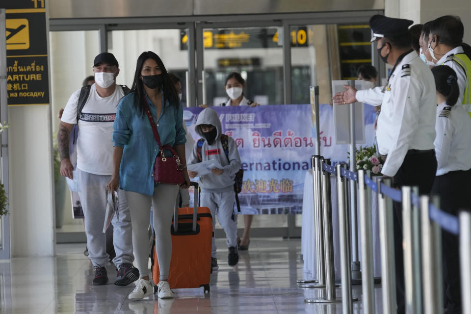 The first group of tourists arrive on an Etihad flight from Abu Dhabi at the Phuket International Airport in Phuket, Thailand, Thursday, July 1, 2021. Starting Thursday, Thailand is welcoming back international visitors — as long as they are vaccinated — to its famous southern resort island of Phuket without having to be cooped up in a hotel room for a 14-day quarantine. (AP Photo/Sakchai Lalit)