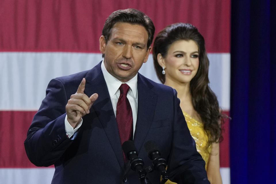 Incumbent Florida Republican Gov. Ron DeSantis speaks to supporters at an election night party after winning his race for reelection in Tampa, Fla., Tuesday, Nov. 8, 2022, as his wife Casey listens. (AP Photo/Rebecca Blackwell)