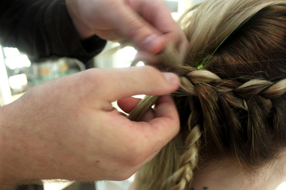 In this Aug. 1, 2012 photo, stylist Cliff Freeman braids the hair of Danielle Maddox, 25, at Maxine salon’s Braid Bar in Chicago. Salons from Los Angeles to New York and cities in between are opening "braid bars," offering special menus of different braid styles for a fixed price. (AP Photo/Caryn Rousseau)