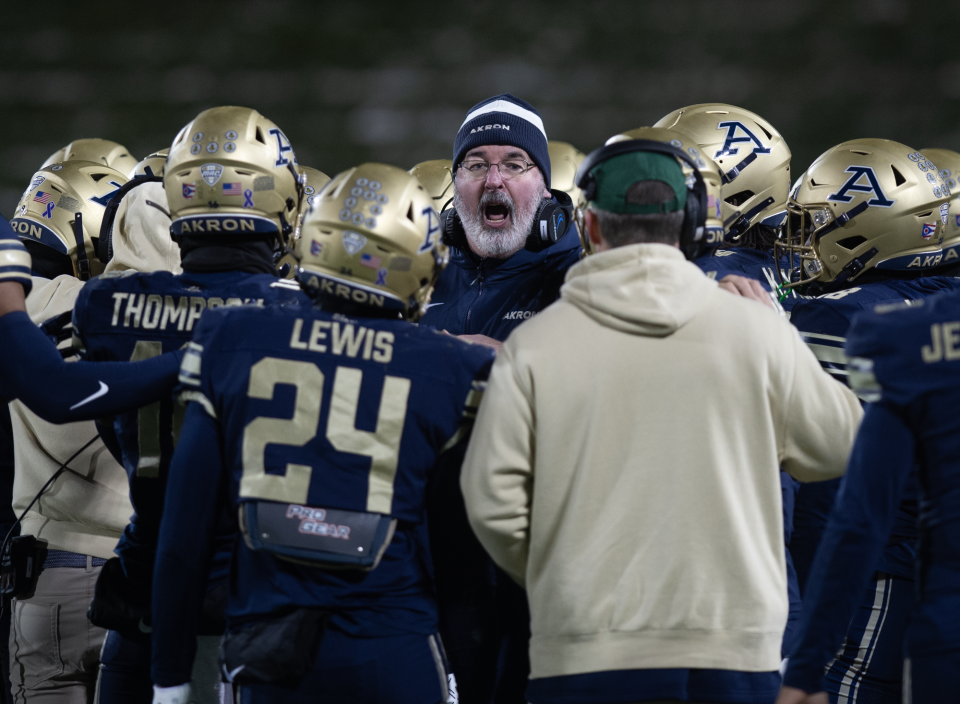 University of Akron coach Joe Moorhead talks to his players during the final timeout of the game Wednesday night against Kent State.