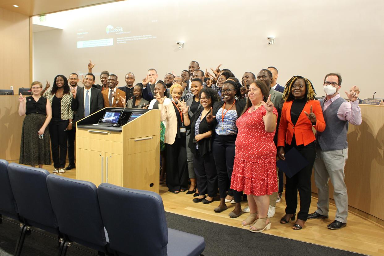 Mandela Washington Fellows proudly display their "Guns Up" during a Lubbock City Council meeting Tuesday.