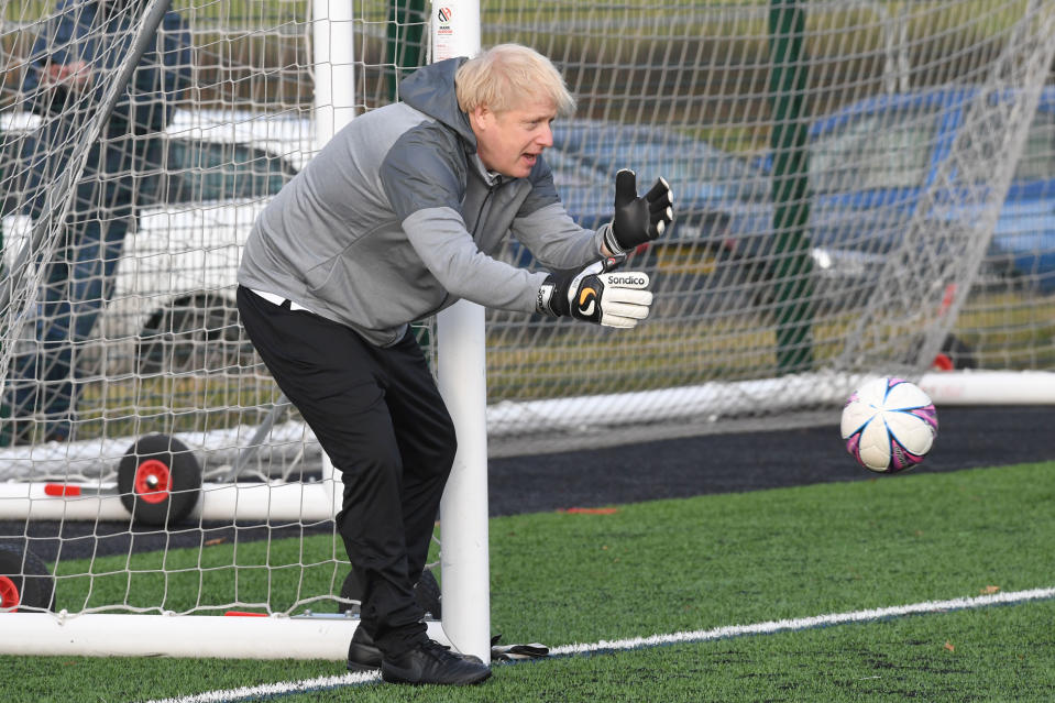 Prime Minister Boris Johnson tries his hand in goal before a football match between Hazel Grove Utd and Poynton Jnr u10s in the Cheshire Girls football league in Cheadle Hume, Cheshire, while on the election campaign trail.