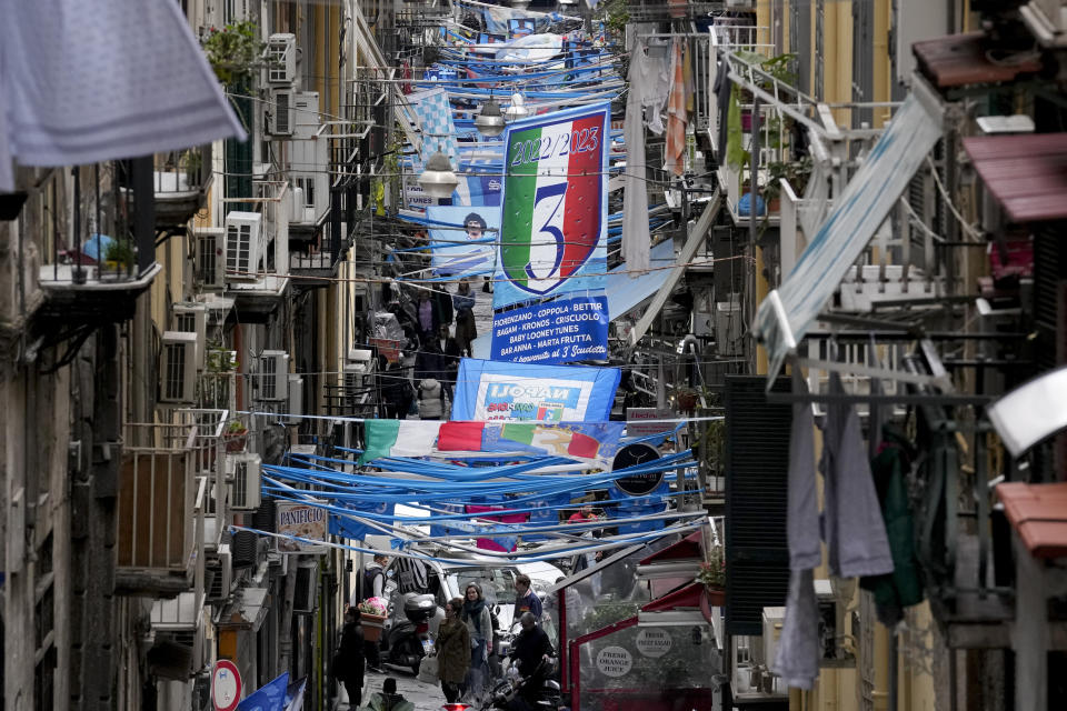 Banners and writings in support of Napoli soccer team are displayed in downtown Naples, Italy, Tuesday, April 18, 2023. It's a celebration more than 30 years in the making, and historically superstitious Napoli fans are already painting the city blue in anticipation of the team's first Italian league title since the days when Diego Maradona played for the club. (AP Photo/Andrew Medichini)