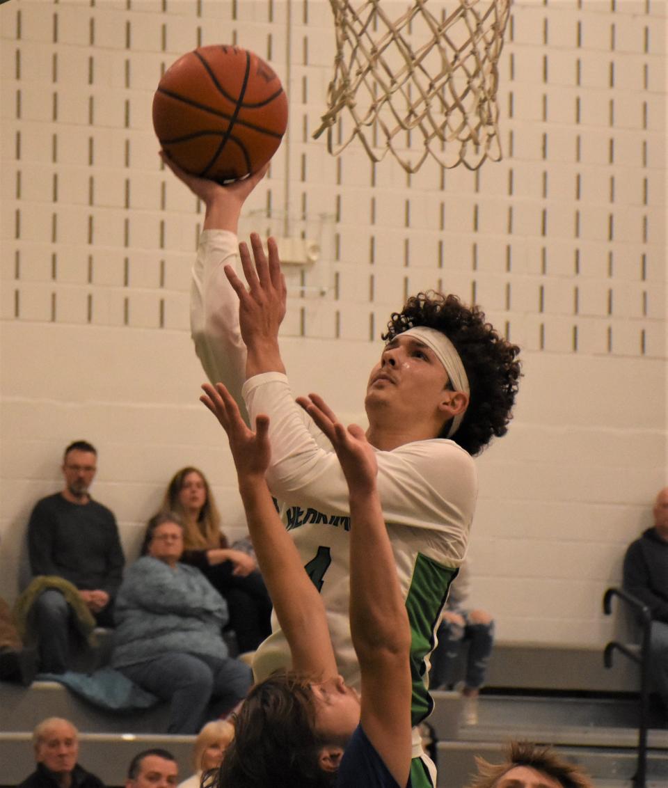 Herkimer Magician Nick Caruso puts up a shot against New York Mills during the first quarter of Tuesday's season-opening game in Herkimer. Herkimer scored the first 14 points on the way to a 73-38 victory.