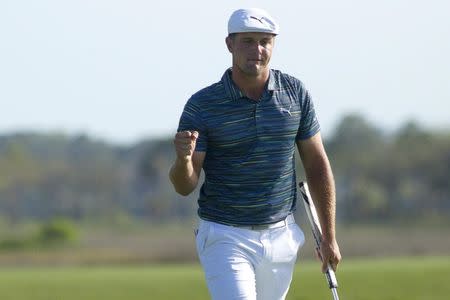 Apr 13, 2018; Hilton Head, SC, USA; Bryson DeChambeau celebrates after putting on the green of the 18th hole during the second round of the RBC Heritage golf tournament at Harbour Town Golf Links. Mandatory Credit: Joshua S. Kelly-USA TODAY Sports