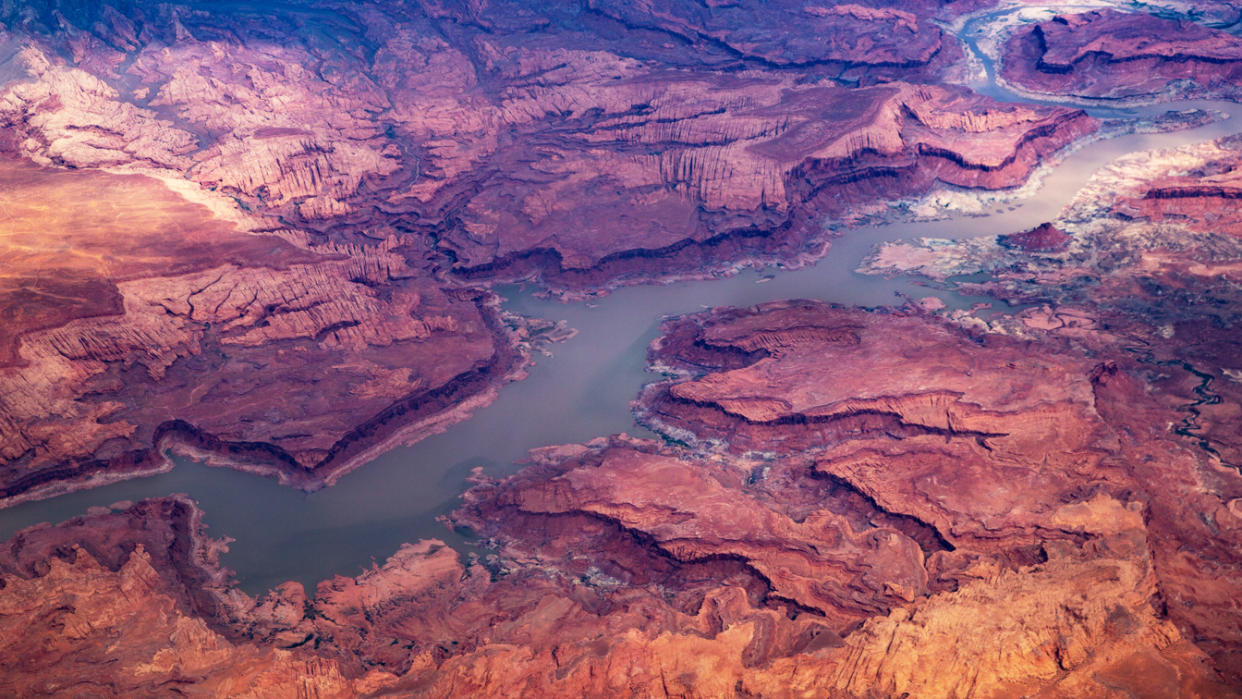 From above, a river flows through a rocky desert landscape.