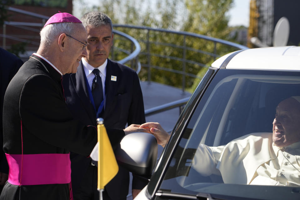 Pope Francis cheers at Athanasius Schneider, left, the auxiliary bishop of Astana, Kazakhstan, at the end of a meeting with priests, religious men and women, seminarians and catechists at the Our Lady Of Perpetual Help Cathedral in Nur-Sultan, Kazakhstan, Thursday, Sept. 15, 2022. Pope Francis is on the last day of his three-day trip to Kazakhstan. (AP Photo/Andrew Medichini)