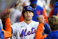 New York Mets' Brandon Nimmo celebrates with teammates after hitting a home run during the fourth inning in the first baseball game of a doubleheader against the Washington Nationals, Tuesday, Oct. 4, 2022, in New York. (AP Photo/Frank Franklin II)
