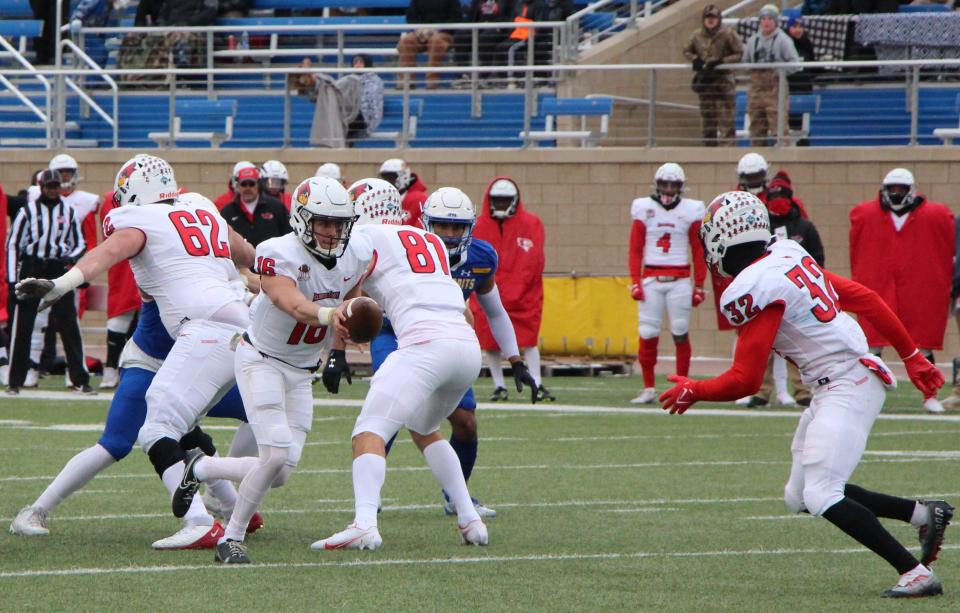 Illinois State Redbirds quarterback Tommy Rittenhouse hands off to Wenkers Wright in the second quarter of their game with South Dakota State on Saturday. SDSU won 31-7.