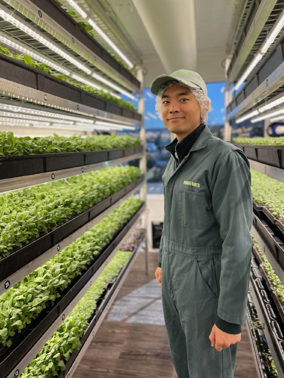 Hank Kim, operations manager at Square Roots, stands in a climate controlled hydroponic grow room in Kenosha.