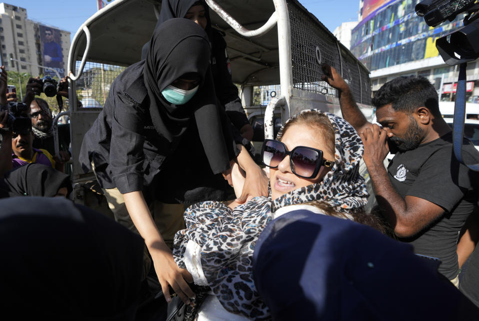 Police detain a supporter of Pakistan's former Prime Minister Imran Khan who along with others are protesting against the arrest of their leader, in Karachi, Pakistan, Thursday, May 11, 2023. Pakistan's Supreme Court has ordered the release of Khan, two days after his arrest sparked countrywide violence. (AP Photo/Fareed Khan)