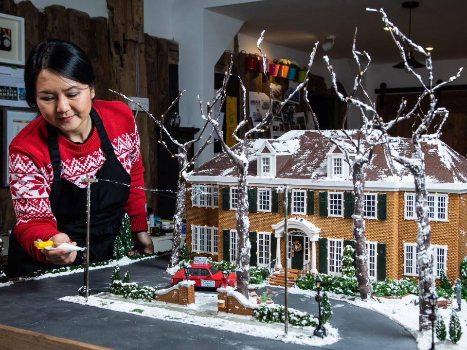 Cake designer Michelle Wibowo works on her gingerbread version of the McCallister house