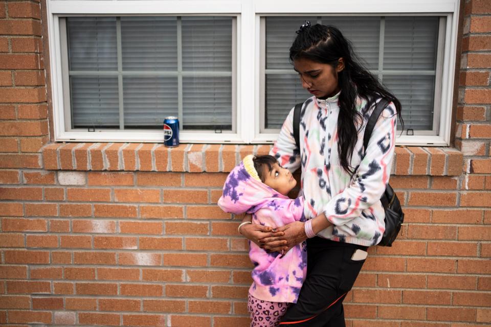 Sindiya Darji, a single mom of three, who came to the U.S. with refugee status, tries to keep her youngest daughter, Marina Kaami, 5, warm on Dec. 9, 2023, as she waits outside of the management office of Colonial Village apartments on Columbus' East Side. The family has no heat in her apartment, and the city ordered residents of all apartments without heat to be out by Friday, Dec. 15, 2023. The management at Colonial Village has given all of its residents until Dec. 31 to find new housing.