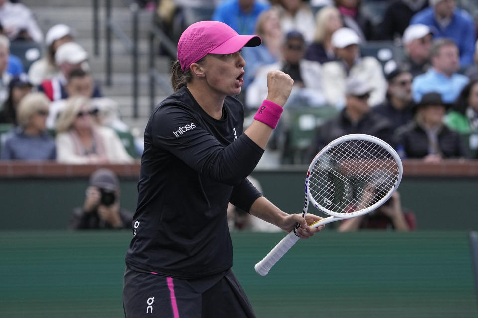 Iga Swiatek, of Poland, celebrates winning a point against Marta Kostyuk, of Ukraine, during a semifinal match at the BNP Paribas Open tennis tournament, Friday, March 15, 2024, in Indian Wells, Calif. (AP Photo/Mark J. Terrill)