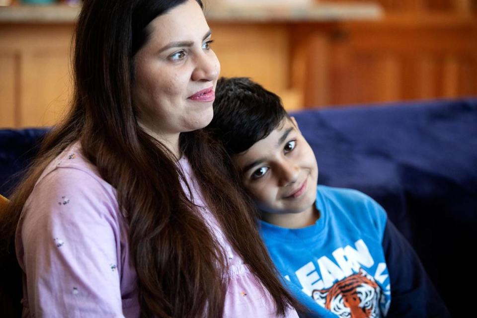 Negina Barakazai and son Ben Yamin share a poignant moment in their new Cambria home. The Barakazai family spent more than two years in hiding in Afghanistan and Pakistan before arriving in the United States on Sept. 6, 2023.