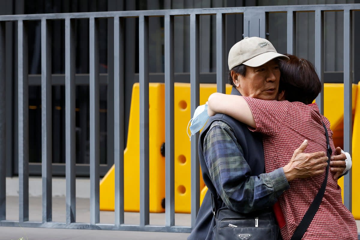 A relative hugs a man who was rescued from a remote area, following the earthquake, in Hualien, Taiwan (Reuters)