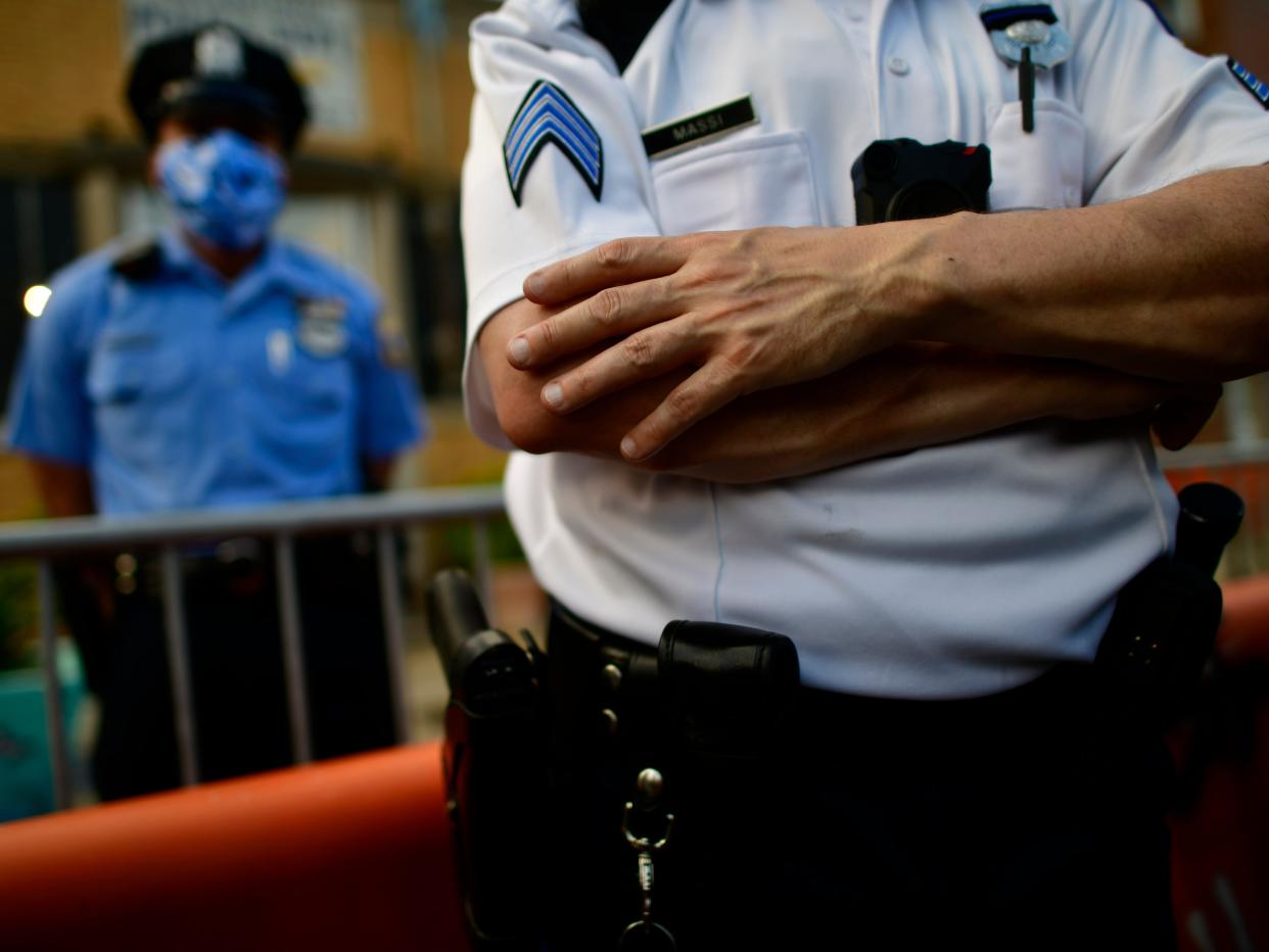 A police officer crosses his arms while observing protesters outside the 26th Precinct on June 3, 2020, in Philadelphia, Pennsylvania.