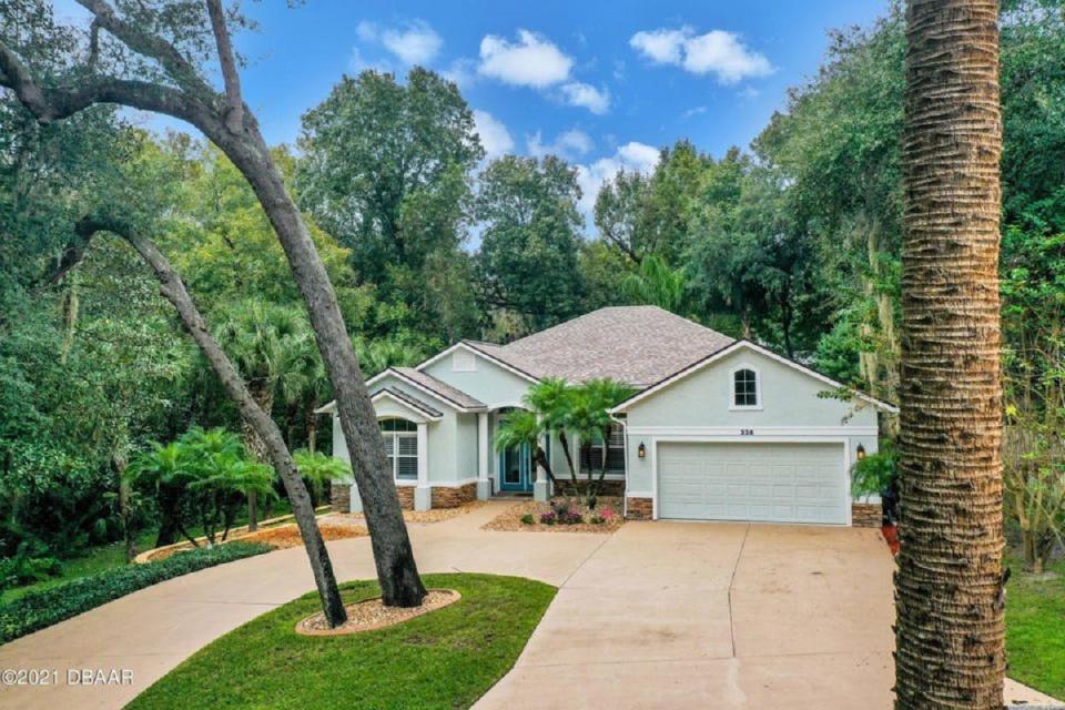 This beautiful custom-built pool home is situated on nearly a half-an-acre, private, tropical lot that boarders Groover Creek in the Ormond Beach gated subdivision of Tymber Creek.