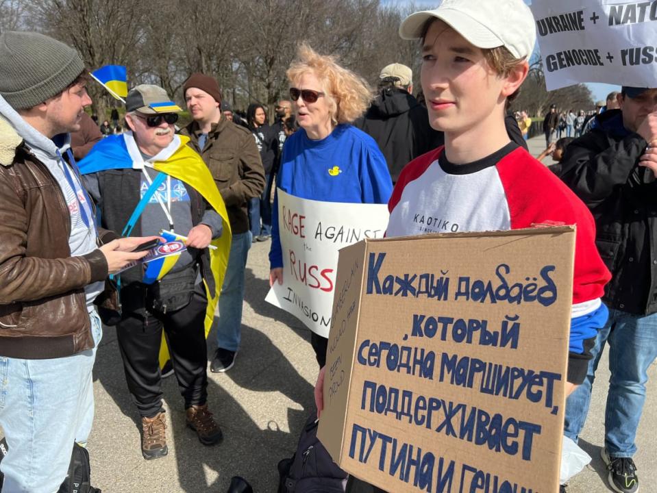 <div class="inline-image__caption"><p>Unofficial leader of the anti-Russia contingent, Riley Geary, seen in blue and yellow.</p></div> <div class="inline-image__credit">Zachary Petrizzo</div>