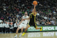 Oregon guard Jackson Shelstad (3) shoots over Colorado guard Luke O'Brien (0) during the first half of an NCAA college basketball game in the championship of the Pac-12 tournament Saturday, March 16, 2024, in Las Vegas. (AP Photo/John Locher)