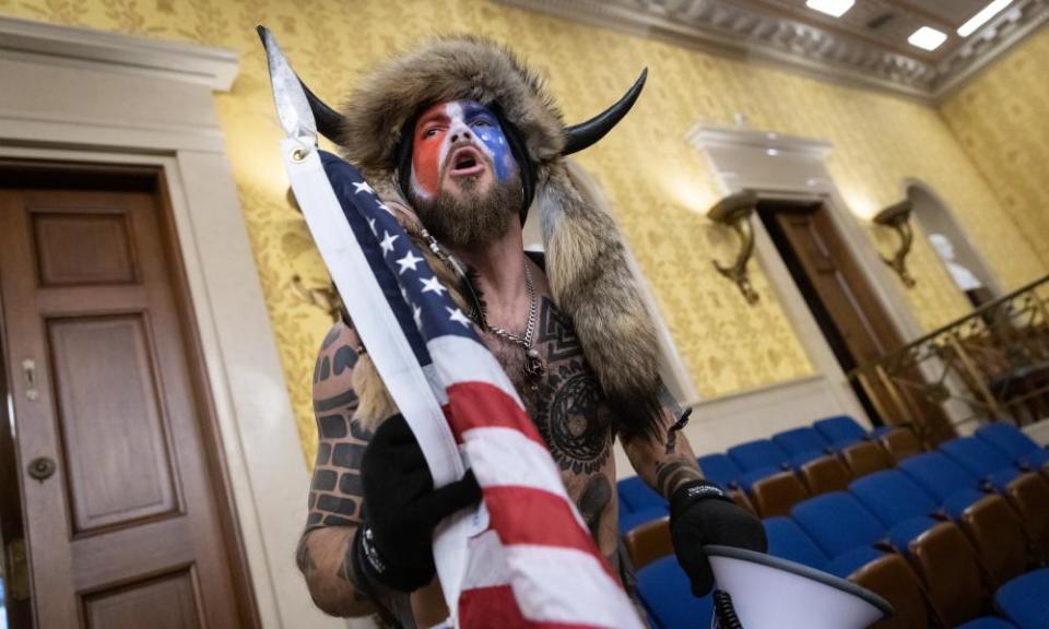 Jacob Chansley, also known as the ‘QAnon Shaman’, screams inside the US Senate chamber on January 6.
