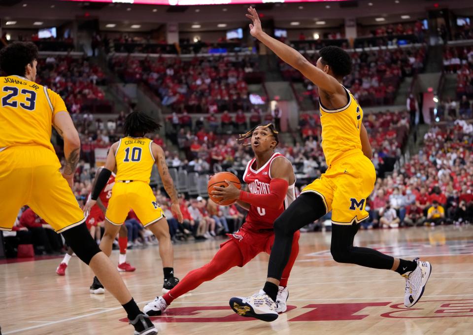 Ohio State Buckeyes guard Meechie Johnson Jr. (0) dribbles around Michigan Wolverines guard Kobe Bufkin (2) during the first half of the NCAA men's basketball game at Value City Arena in Columbus on March 6, 2022. Michigan won 75-69.