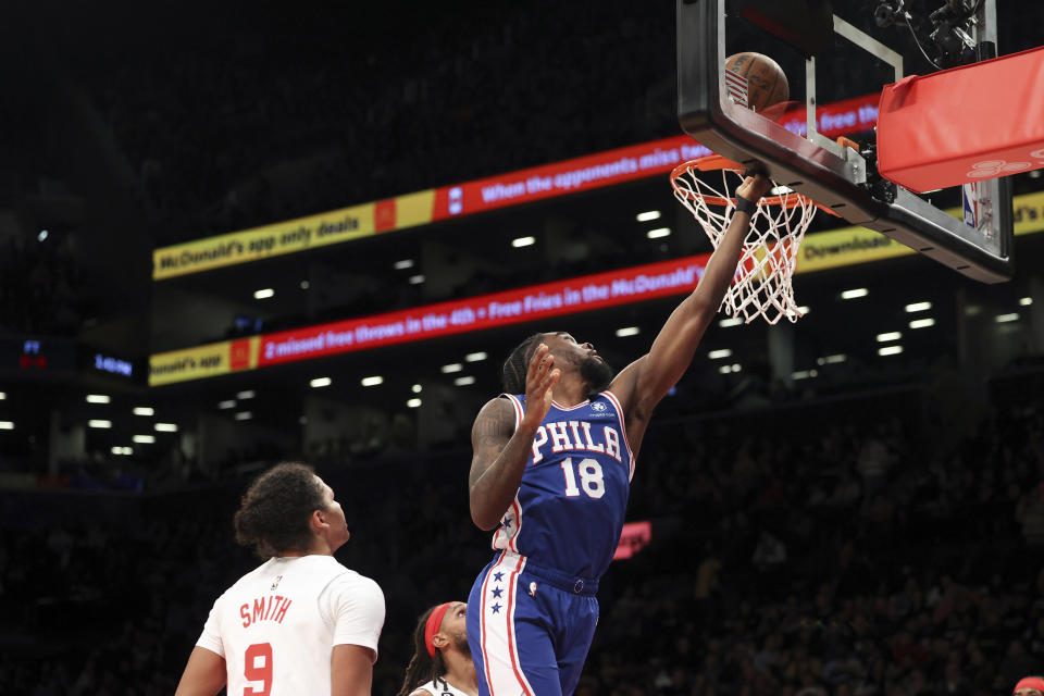 Philadelphia 76ers guard Shake Milton (18) scores a basket as Brooklyn Nets guard Dru Smith (9) watches during the first half of an NBA basketball game, Sunday, April 9, 2023 in New York. (AP Photo/Jessie Alcheh)