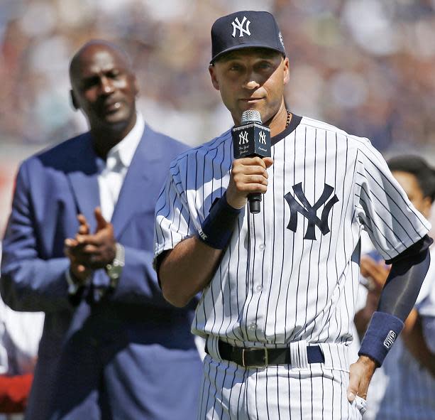 Michael Jordan watches on while Derek Jeter speaks in a pregame ceremony honoring his career in 2014. (AP)