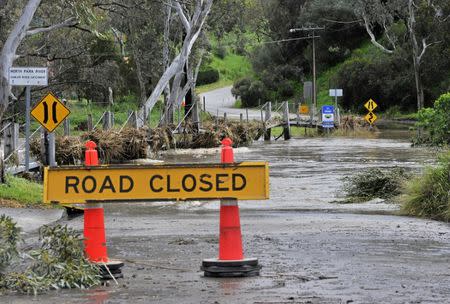 A sign is displayed on a road that is closed due to flooding near the town of Tanunda in the Barossa Valley, located north of Adelaide, after severe storms in the state of South Australia, September 30, 2016. AAP/David Mariuz/via REUTERS