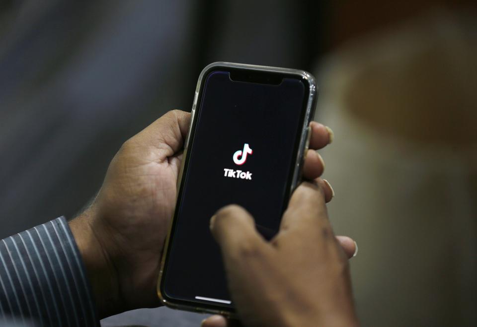 FILE - In this July 21, 2020 file photo, a man opens social media app 'TikTok' on his cell phone, in Islamabad, Pakistan. President Donald Trump said Saturday, Sept. 19, 2020 heâ€™s given his â€œblessingâ€ to a proposed deal between Oracle and Walmart for the U.S. operations of TikTok, the Chinese-owned app heâ€™s targeted for national security and data privacy concerns. (AP Photo/Anjum Naveed, File)