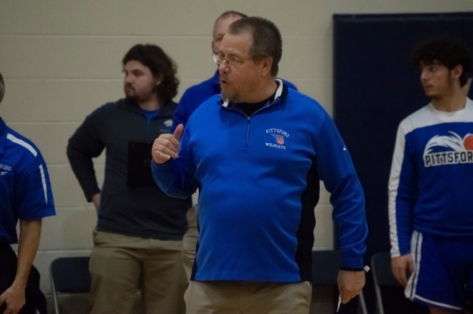 During a break in game action, Pittsford head coach Mike Burger discusses a call on the court with an official.