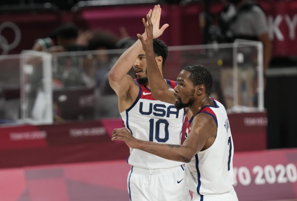 United States' Kevin Durant (7), right, and Jayson Tatum (10) celebrate during men's basketball gold medal game against France at the 2020 Summer Olympics, Saturday, Aug. 7, 2021, in Saitama, Japan. (AP Photo/Luca Bruno)