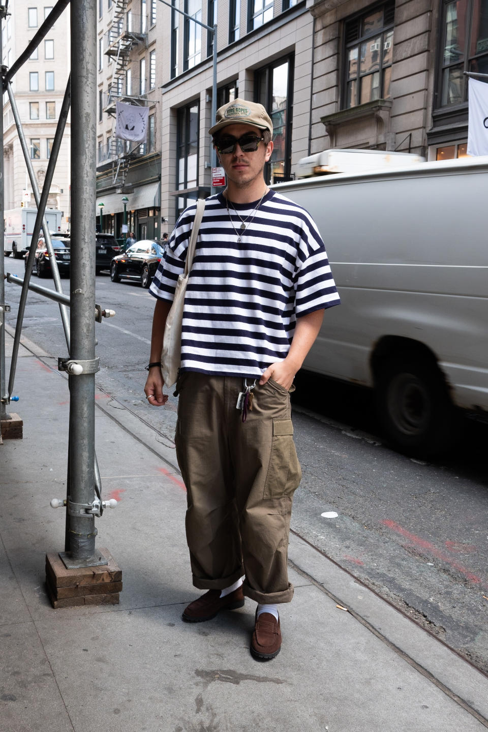 man in striped shirt and baggy pants in new york