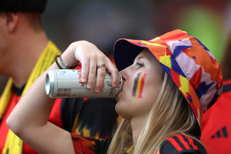 DOHA, QATAR - NOVEMBER 27: A fan takes a drink from a Budweiser Zero can during the FIFA World Cup Qatar 2022 Group F match between Belgium and Morocco at Al Thumama Stadium on November 27, 2022 in Doha, Qatar. (Photo by Elsa/Getty Images)