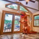 <p>Bambi Chase, who works for Nebraska Realty, said she had seen a number of T. rex-costume gimmicks floating around the internet. (Photo: Nebraska Realty/Caters News) </p>