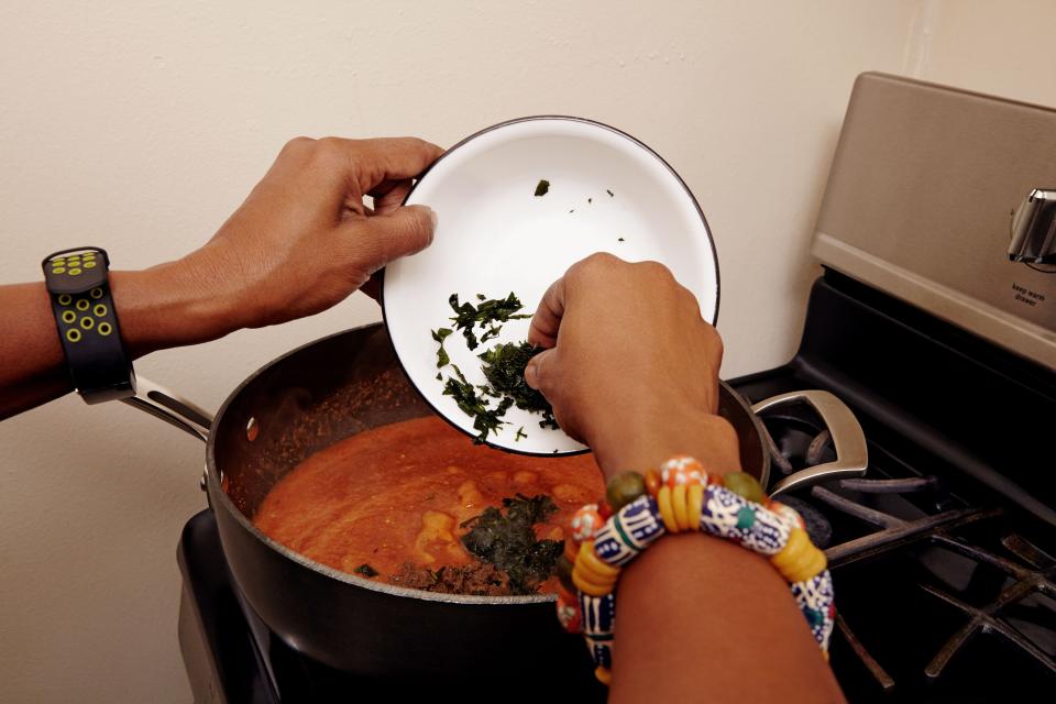 Here, Seriki adds bitter leaf, a traditional Nigerian herb, to her obe ata—the “mother sauce” of West African cooking.