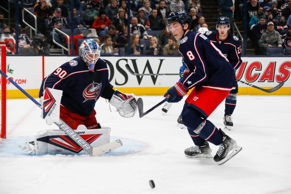 Columbus Blue Jackets goaltender Elvis Merzlikins (90) and defenseman Zach Werenski (8) track the puck during the second period of the NHL game against the Vancouver Canucks at Nationwide Arena in Columbus, Ohio Nov. 26.
